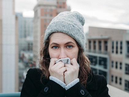 woman covering nose